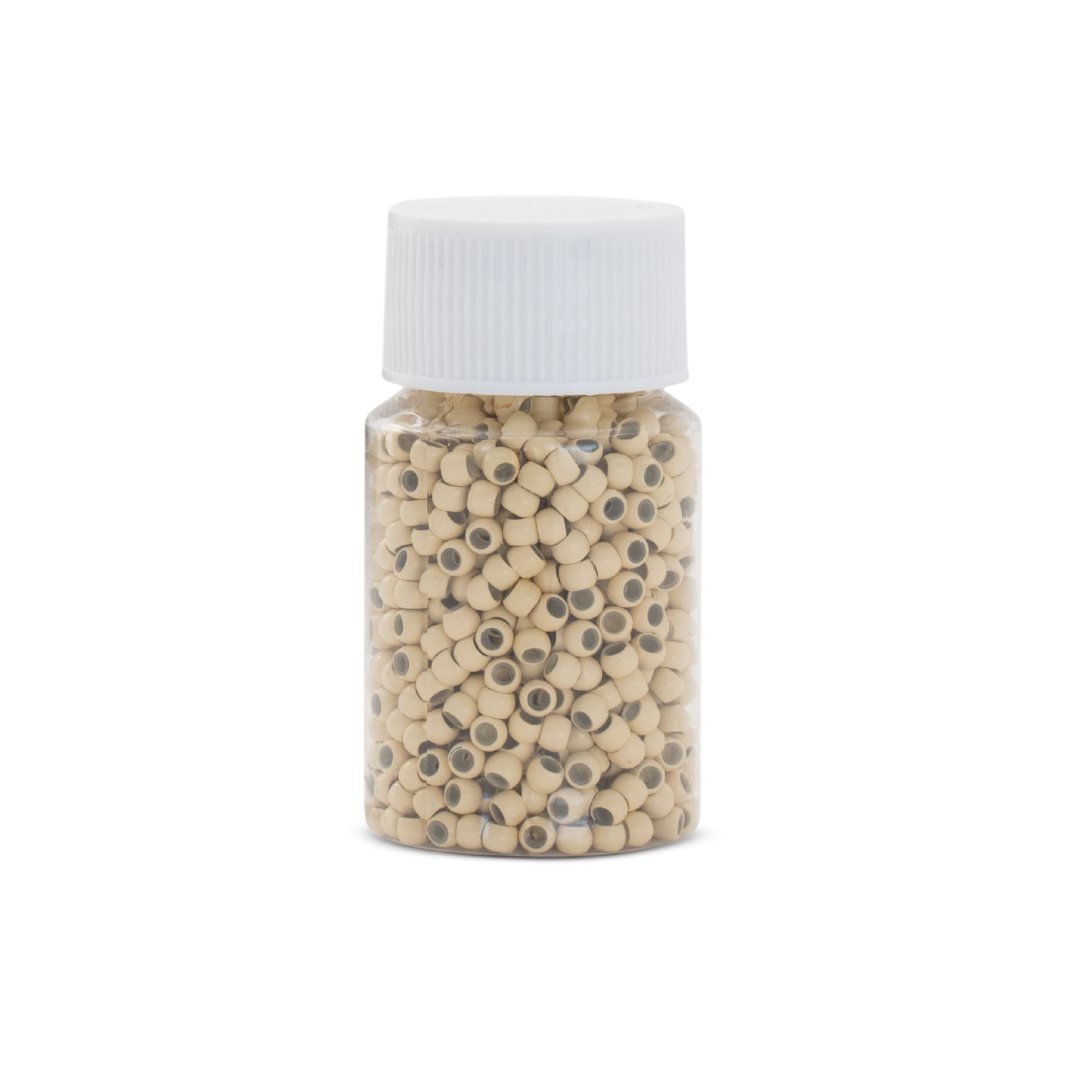 Jar of small beads with a white lid on a white background
