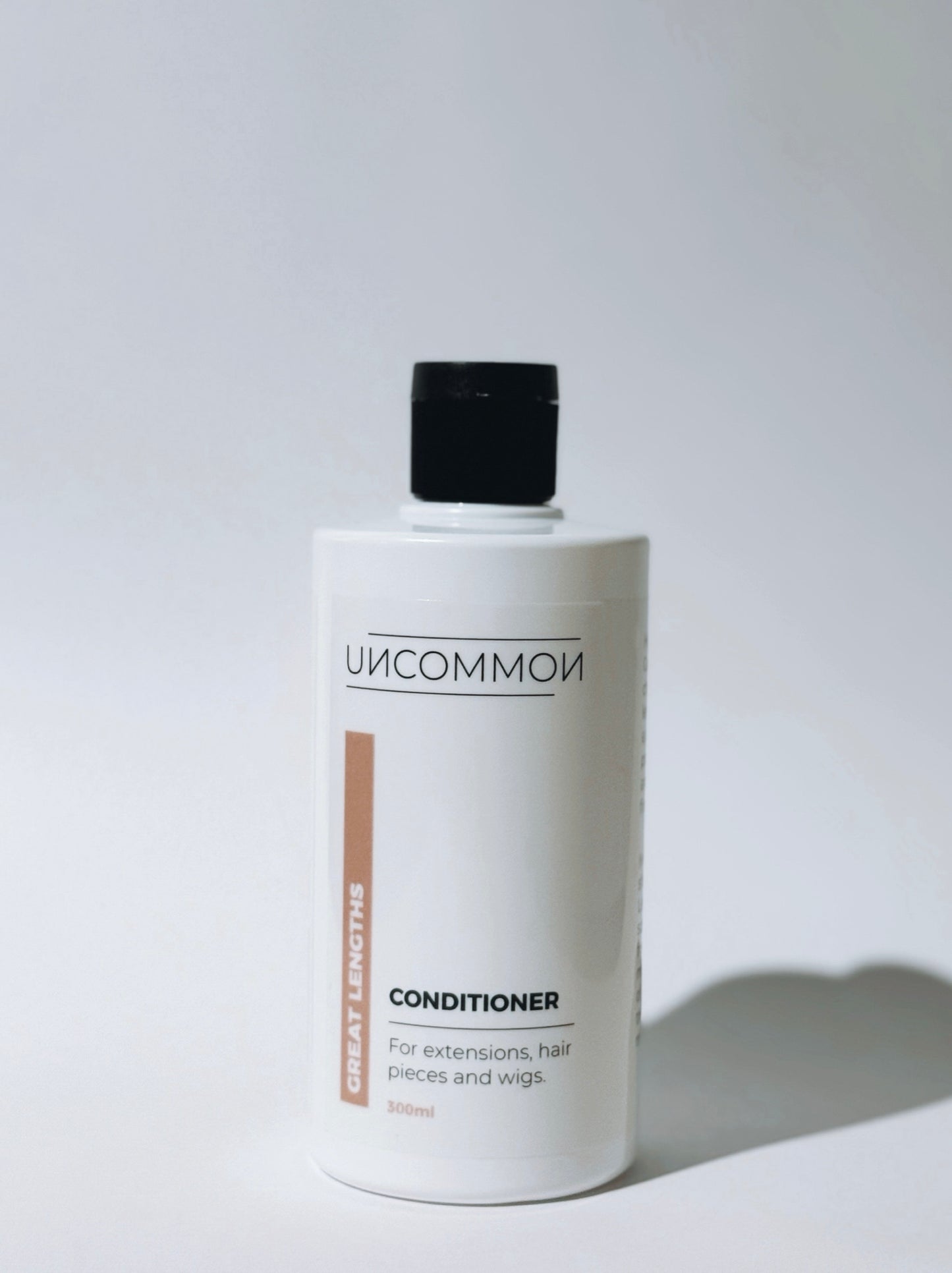 Uncommon conditioner bottle on a white background