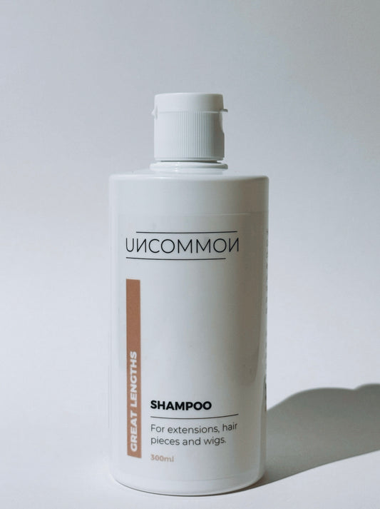 Uncommon shampoo bottle for extensions on a white background