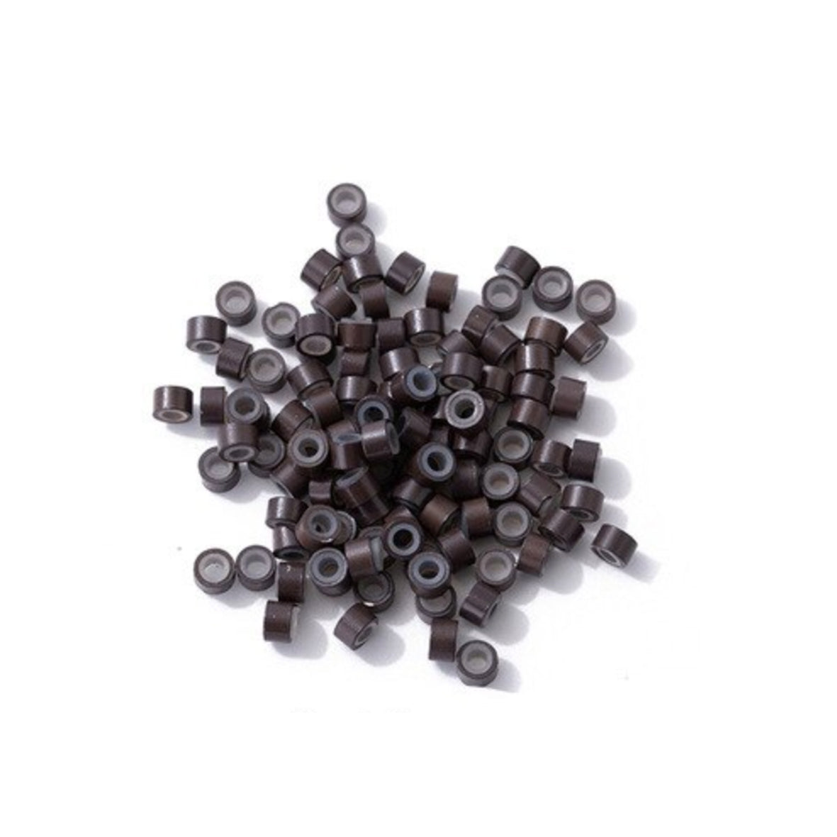 A collection of brown micro rings with soft silicon insert scattered on a white surface.